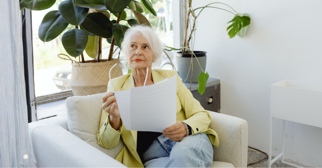 Woman over 45 sitting at home reviewing medical documents, representing metabolic health decisions after midlife